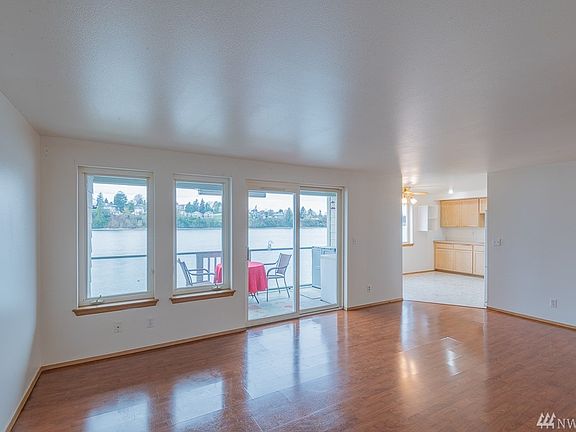 Living room with laminate hardwood floors.  Sliding glass door leading out to covered deck.