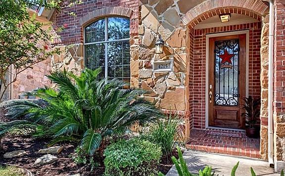 Come on in! The double leaded glass door and the tasteful use of brick and stone in combination with with brick pavers on the front porch add to the inviting appearance of the entrance way.