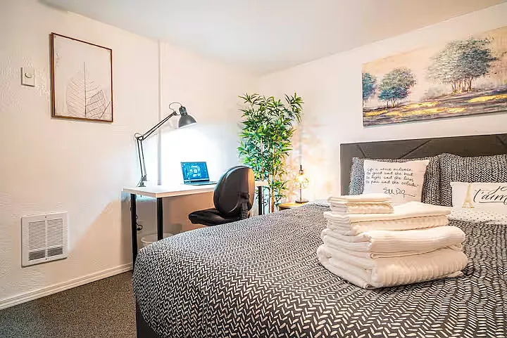 Bedroom 1 includes a queen-sized bed with memory foam mattress for a comfortable night sleep, an air-conditioner (kept in the bedroom closet during winter as the room stays cool) and a computer desk for working from home.