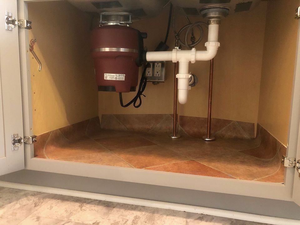 Plumbing and disposer under kitchen sink
