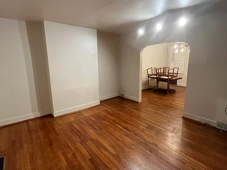 Living room with view of dining room in the background