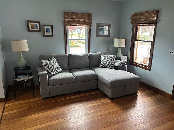 New sofa/chaise in living room. Slide out/pop up cushions turn sofa into queen sized bed or very comfy place to watch smart TV provided.
