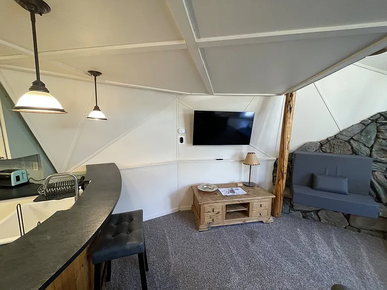 Wall mounted flatscreen TV in living area can be positioned for optimal viewing wherever you want on the main level.