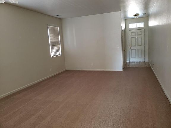 This is the front 1/2 of the front living room. You can also see the SOHO or 4th bedroom notched out next to the front door. You can also see just the tip of the ceiling light fixture in top left hand corner of this picture.