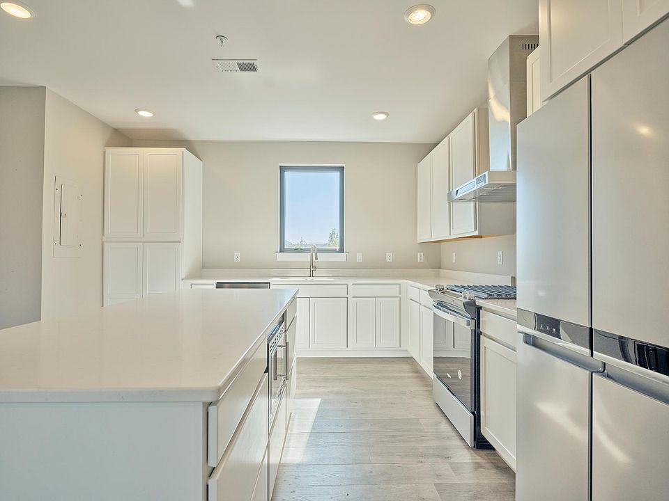 Kitchen with gas range large island and two pantry cabinets.