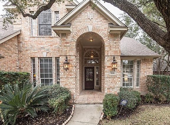 Soaring two story tall porch greets your guests.