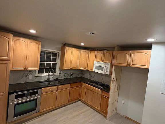 modern kitchen with tiles backsplash, refrigerator will be provided