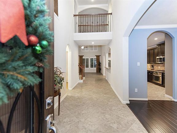Stunning extended entry with tile and wood flooring through the home.