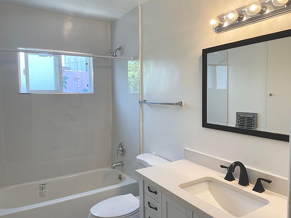 Newly reglazed bathroom with sleek armoire