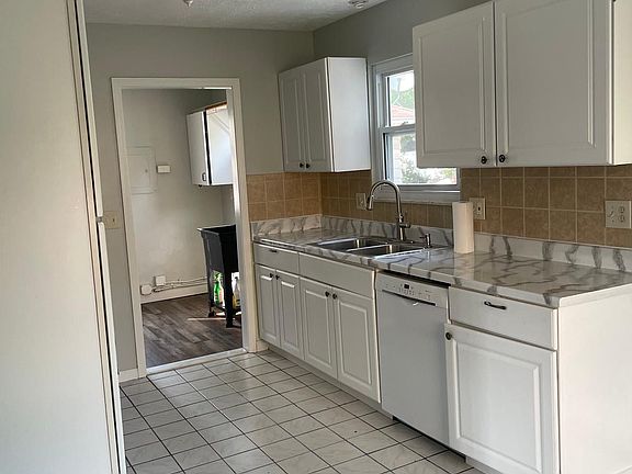 Kitchen with a view of the laundry room