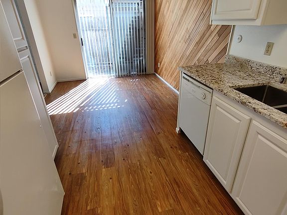 sliding glass door leading to fenced in patio