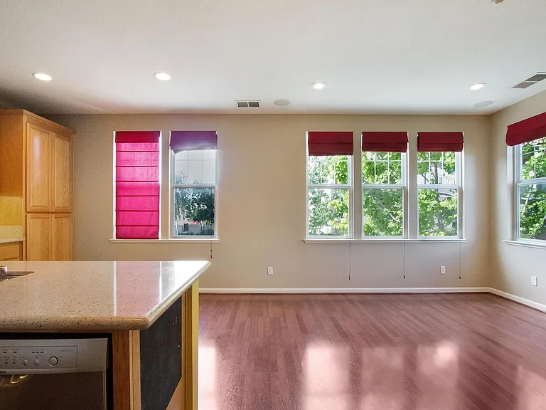 Kitchen and the family room. Window furnishings have been replaced with new ones.