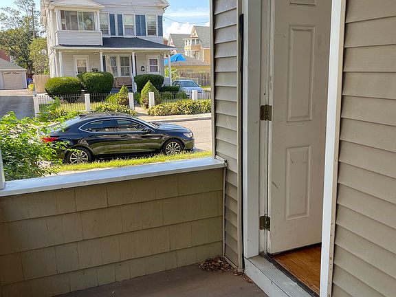 View from side balcony toward Hazel St, with entrance back into living room.