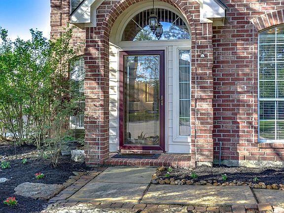 The beautiful curb appeal is accented by a large flower bed and gorgeous red brick.