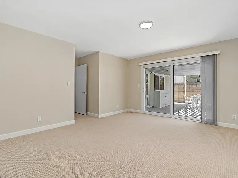 Spacious Primary Suite with sliding doors to the outdoor patio~