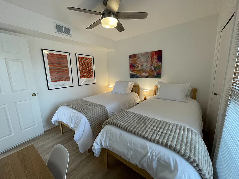 Upstairs bedroom in 2 twin XL configuration with workspace