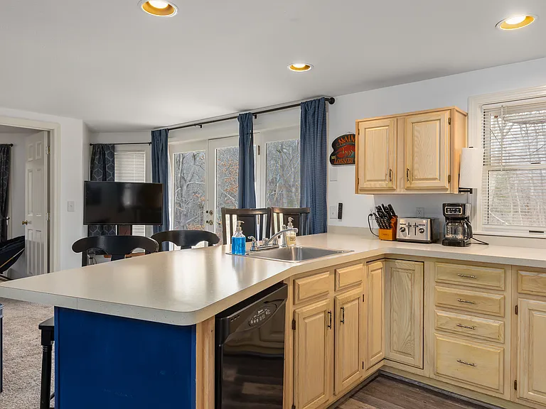 Kitchen. Refrigerator, electric stove and oven, microwave, coffee maker, toaster, and full plates, bowls, glasses, mugs, forks, knives, spoons, pots and pans, and kitchen utensils.