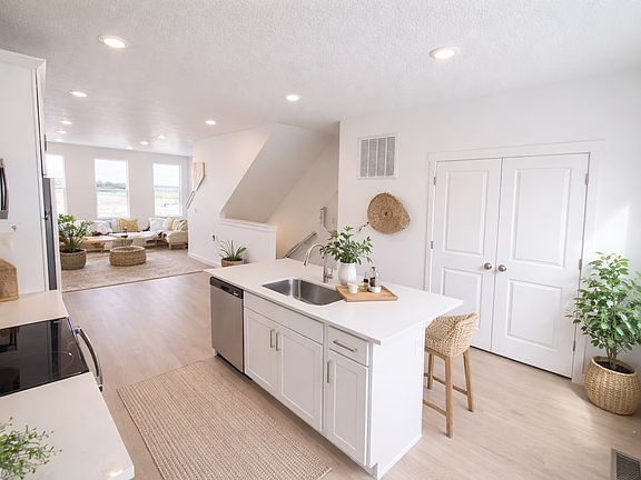 Open kitchen and living area in Cameron floor plan at Beacon Pointe Saratoga Springs Utah