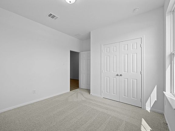 An additional view of the second bedroom and closet.