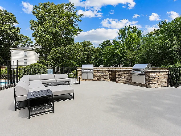 Entertain in style with our modern outdoor kitchen and stone grills surrounded by beautiful landscaping.