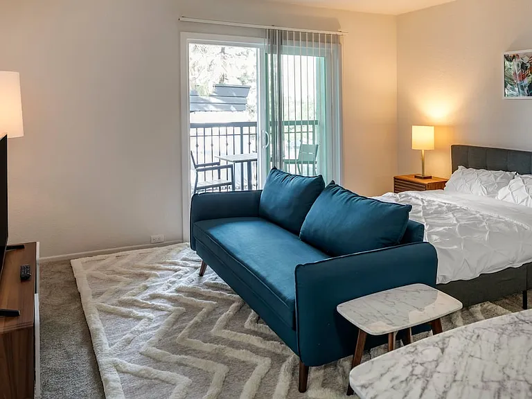 Furnished+ apartment homes come outfitted with a sofa, side chair, side table, coffee table, TV stand and 50" Television (Representative Image exact items and style of furnishings may vary)