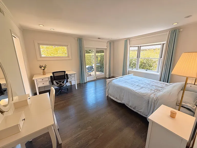 Primary bedroom with sliding door to backyard deck