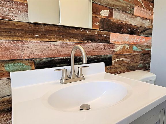 Artist designed wood accent wall and designer finishes throughout this bathroom.