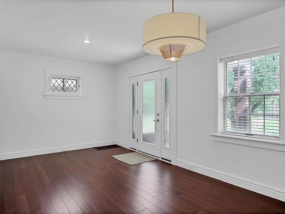 A view from the Dining Area to the Main Entry gives  you an idea of the abundant natural light that flows through the space.  The window overlooks the front garden and lawn.