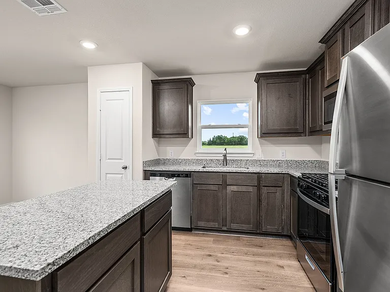 The kitchen has stainless steel appliances.