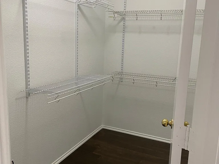 Primary bedroom walk-in closet