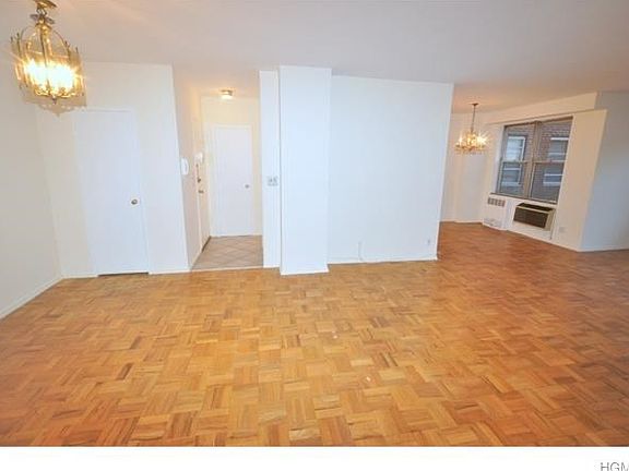 Updated Kitchen with Corian counters, dishwasher, range, microwave, refrigerator and roll out cabinet inserts.