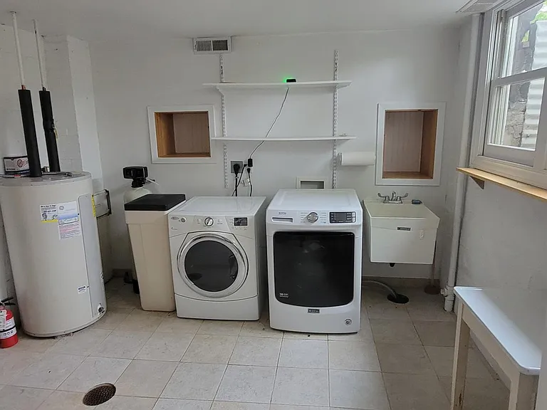Water heater, water softener, utility sink, proper floor drain, lots of Natural light!