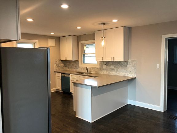 Kitchen with peninsula and view to first floor bedroom to right