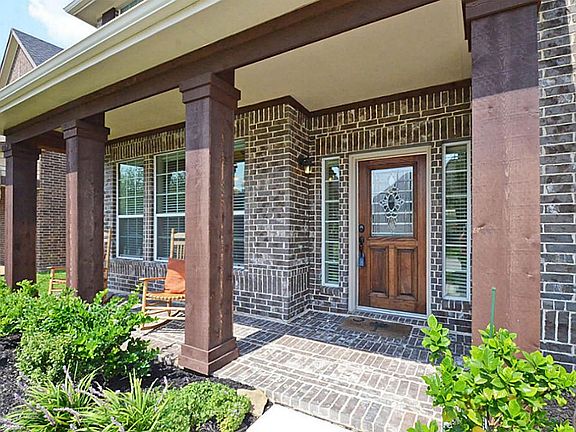 Leaded glass front entry with stained cedar columns. Energy saving insulated low E windows, covered porch with room for bistro dining set.