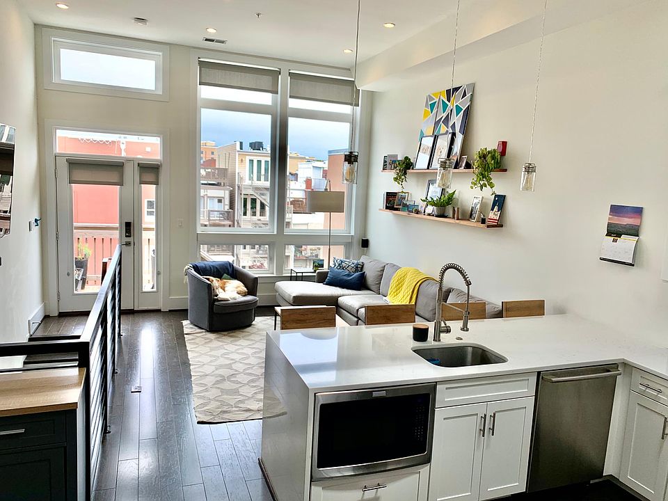 Open-concept kitchen/living room with 12' ft ceilings
