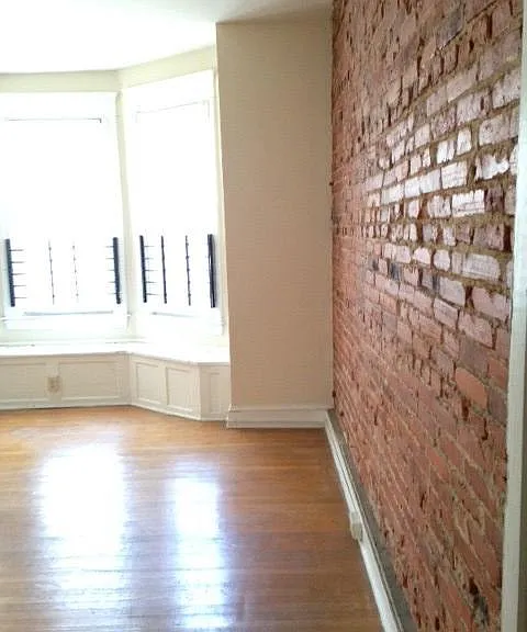 Bedroom with exposed brick wall