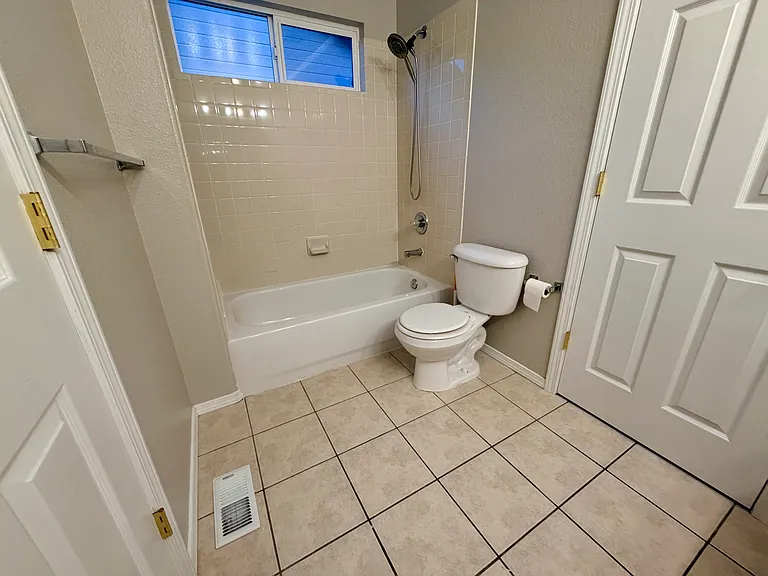 Well-designed Jack-and-Jill bathroom featuring a dual-sink vanity with extended countertop space, separate tub/shower and toilet area, and convenient access from both upstairs bedrooms, providing privacy and functionality for everyday use.