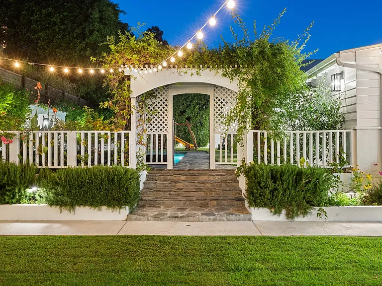String lights weave a mesmerizing glow, transforming the garden into a magical sanctuary under the starlit night sky.
