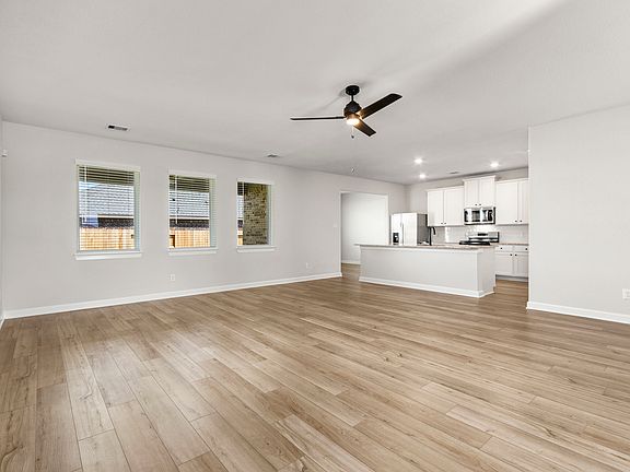 A spacious family room with three large windows