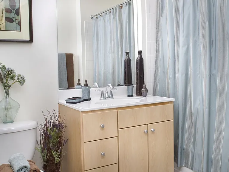 Classic Package I bath with light oak cabinetry, white laminate countertops, and hard surface flooring