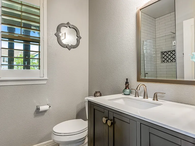 Lower level bath completely remodeled with a new shower, cabinetry, toilet, lighting, flooring, etc