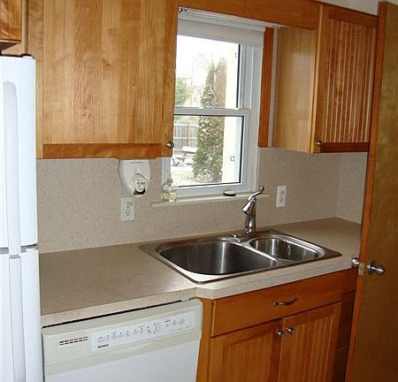 Kitchen w/ built-in dishwasher.