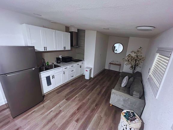 Complete kitchen featuring a stove, microwave, coffee maker and cabinetry.