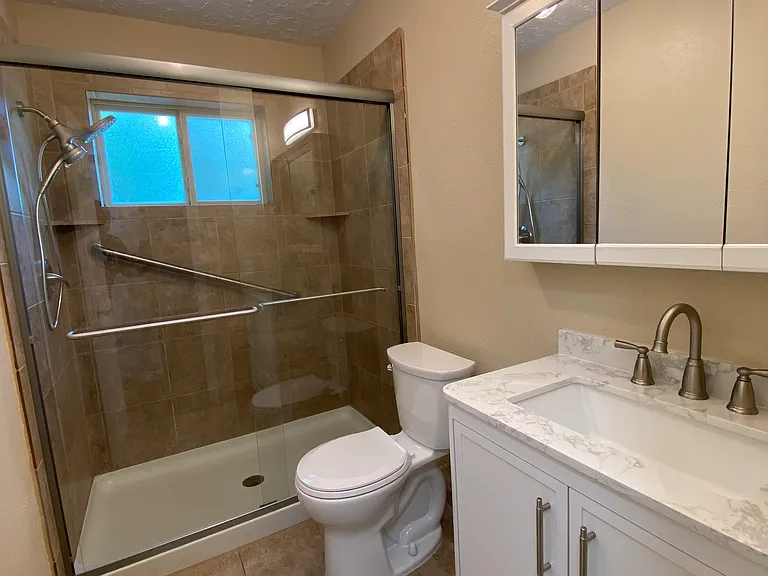 Fully remodeled guest bath with new vanity and fixtures