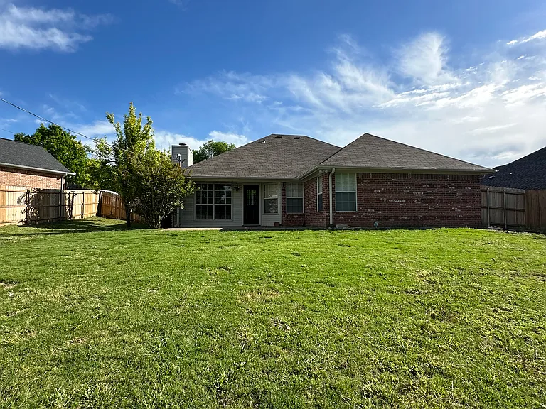 Fully fenced backyard with shed