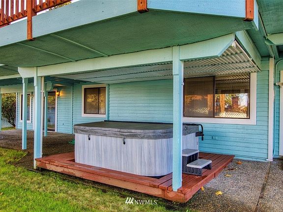 Covered patio with newly covered and functional hot tub for relaxing.
