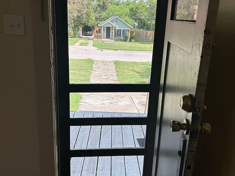 Front door looking out from inside living room.