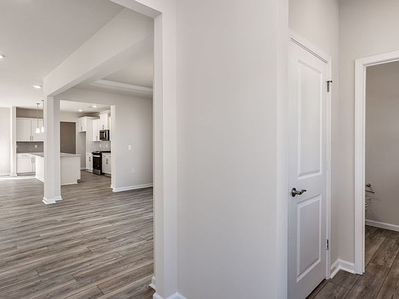 Entry Shows Formal Dining Room and Kitchen - Model Representation
