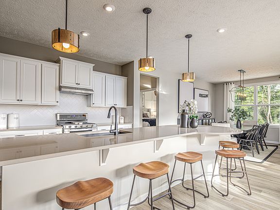 Gourmet Kitchen with White Cabinets and Pendant Lighting