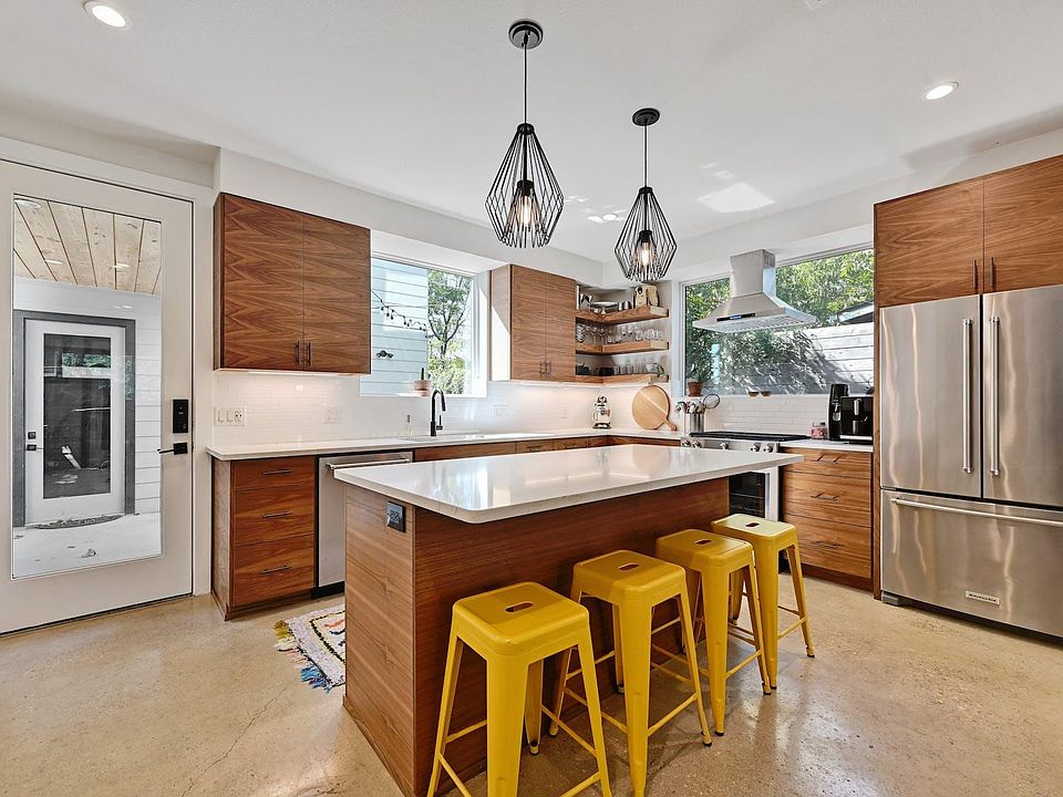 Bar seating allows for company and the glass door on the left leads to the covered walk towards the detached garage. Easy Grocery transport : )